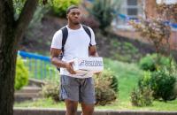 A Glenville State University student carries a box of books from the Barnes and Noble Pioneer Campus Store. (GSU Photo/Kristen Cosner)