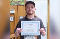 Jared Bishop with the certificate for his recent EnerGIS scholarship.