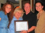 Bluegrass honorary membership to Miss Dixie Hall Megan Darby, Buddy Griffin, and Rebekah Long granting Miss Dixie Hall an honorary membership