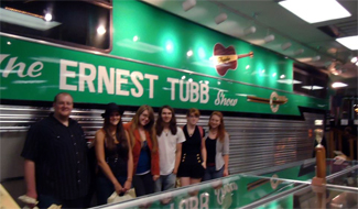 The band posing beside the Ernest Tubb show bus