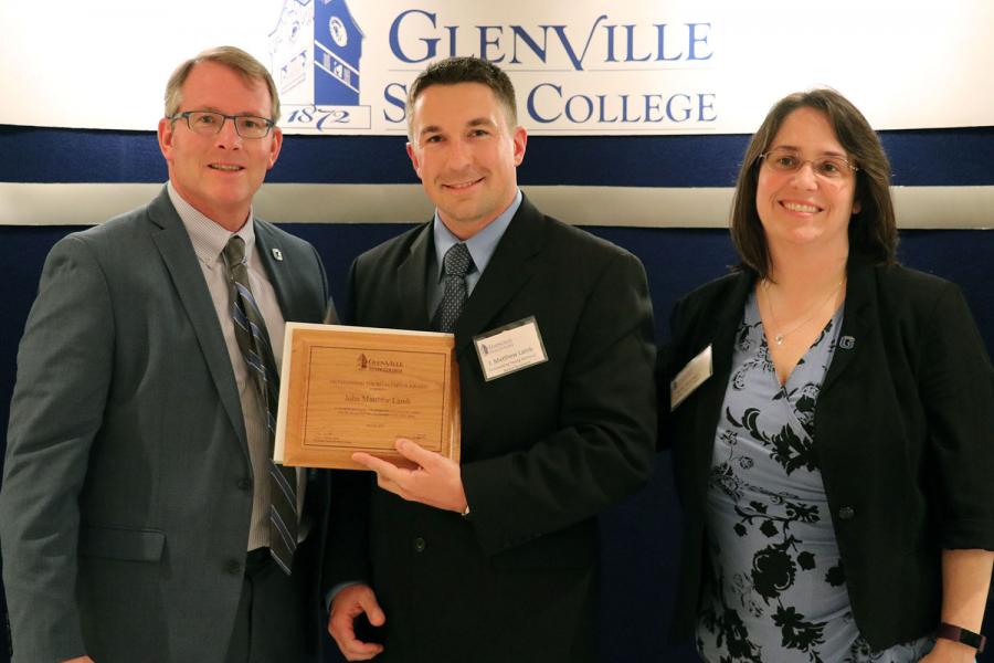 Outstanding Young Alumnus award recipient Matt Lamb with President Pellett (left) and award presenter Julie Yearego (right)