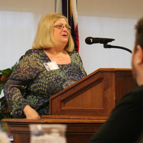 Susan Lilly, accepting the Outstanding Young Alumni Award on behalf of her son Jacob Lilly