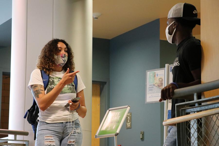 Two Glenville State students chat inside the Mollohan Campus Community Center between classes