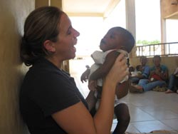 Amanda with an infant at an orphanage