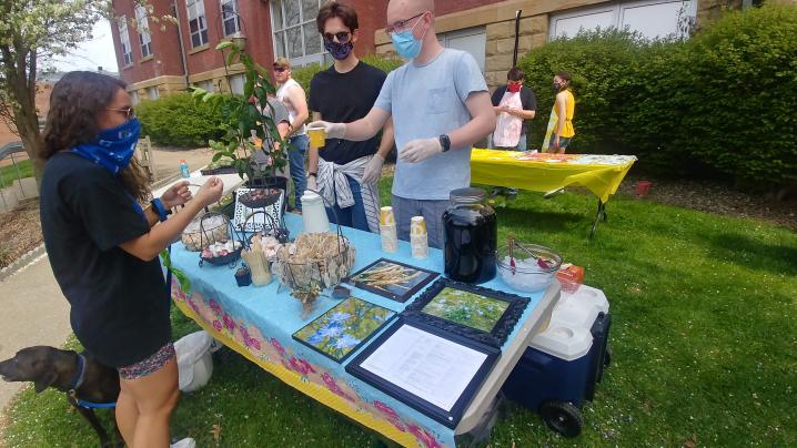 Students handing out tea and lemon bread