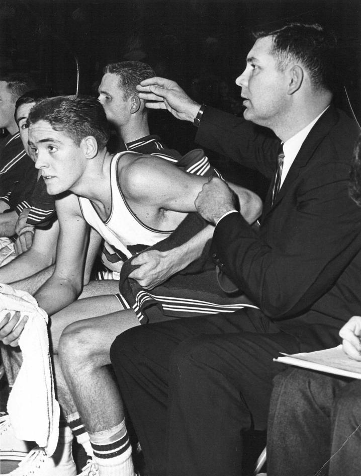 Coach Leland Byrd (right) on the sidelines with the Glenville State College Pioneer basketball team during the 1958-59 year. Byrd is seated next to fellow GSC Athletic Hall of Fame inductee, Larry Gandee.