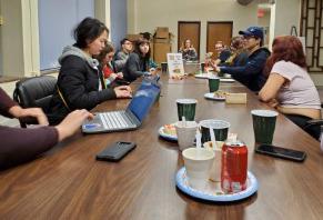 ISA members sitting around a long, wood table