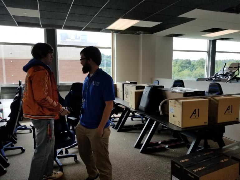 Logan Harrison chats with student in E-Sports Center E-Sports Center