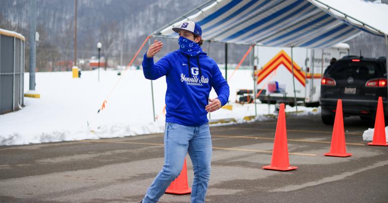 Vaccine Clinic Glenville State College student Hunter Hickman motions for a driver to pull ahead as they approach the vaccine station during a COVID-19 vaccine clinic held at the Sue Morris Sports Complex in Glenville.