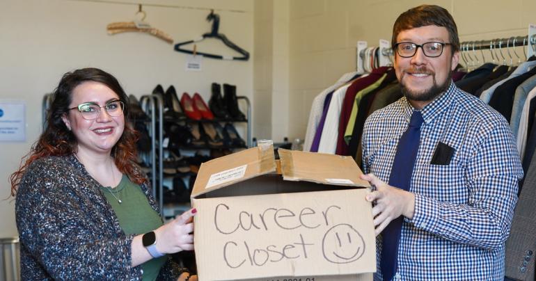 Calhoun Banks Clothing Donation Calhoun Banks Marketing Director Ammanda Frame (left) presents some of the items collected by Calhoun Banks employees to Glenville State University Marketing Director Dustin Crutchfield for the campus Career Closet.