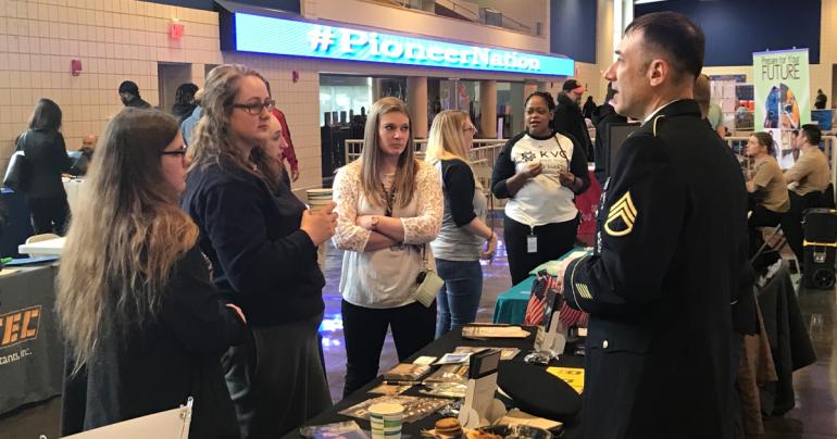 Students talk with a recruiter at a past Glenville State University Career and Graduate School Expo.
