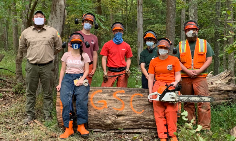 (l-r) Jesse King, Katlyne Rollyson, Dylan Fitzgerald, Jonathan Myles Hutton, Lexi Fletcher, Heather Moore, Johnny King WVDOF employees Jesse King (far left) and Johnny King (far right) are joined by GSC students (l-r) Katlyne Rollyson, Dylan Fitzgerald, Jonathan Myles Hutton, Lexi Fletcher, and Heather Moore after the timber felling and chainsaw safety workshop
