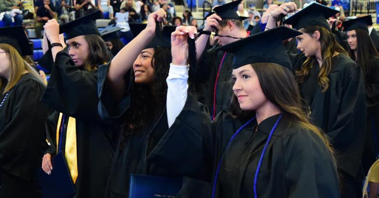 Members of the Glenville State University Class of 2022 move their tassels from right to left, signifying the completion of their degrees and their new status as alumni. (GSU Photo/Sam Santilli)