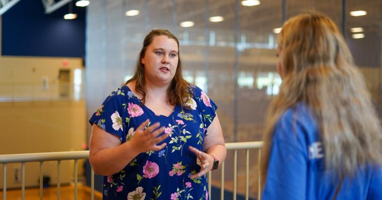 Students at community fair Stormie Alverson (left) speaks to a new student about a campus club during the Glenville State University Community and Campus Organization Fair in 2021. (GSU Photo/Kristen Cosner)