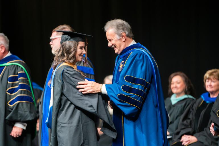 Fall 2024 MBA Graduate Hannah DeMarino and GSU Mark A. Manchin at GSU Fall Hooding Ceremony Fall 2024 MBA Graduate Hannah DeMarino and GSU Mark A. Manchin at GSU Fall Hooding Ceremony