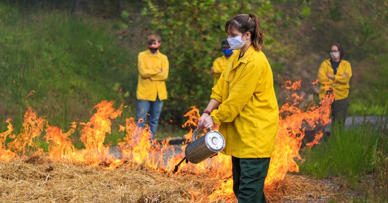 Students in the Forest Technology 214 (Fire Protection) course at Glenville State College take part in training with the West Virginia Division of Forestry to learn about controlled burns and, as pictured here, the safe use of a drip torch (GSC Photo/Kristen Cosner)