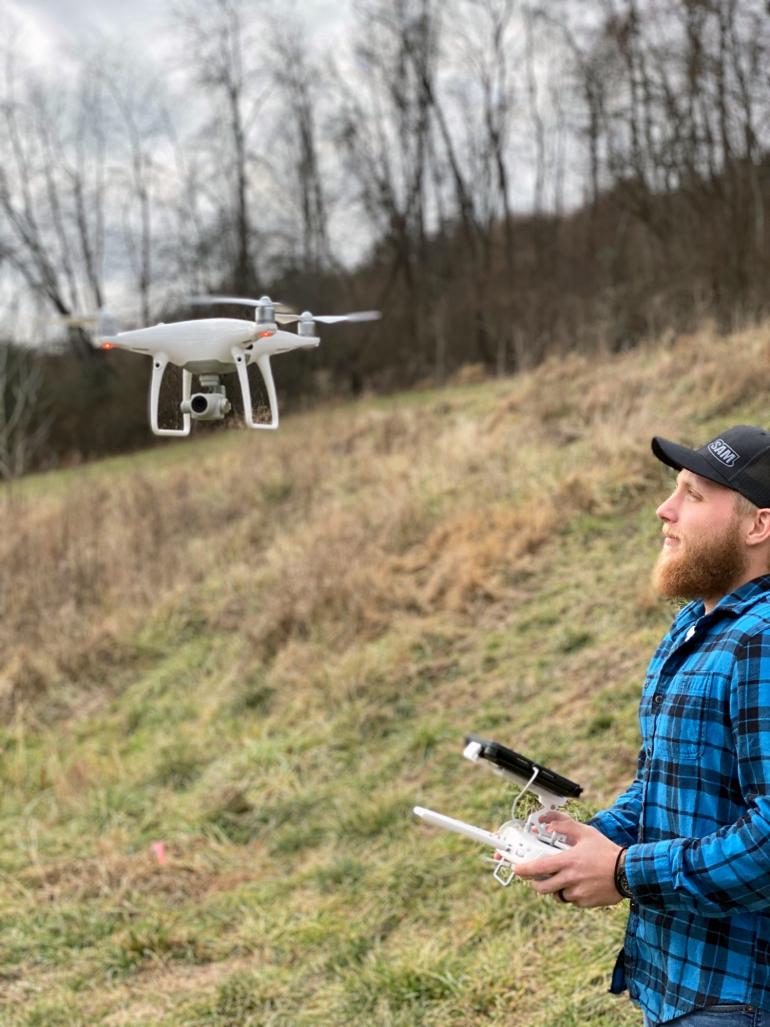 GSC student Jacob Petry flies a drone outside the GSC Department of Land Resources classrooms at the Waco Center