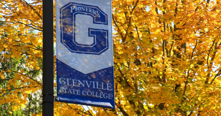 A banner on the campus of Glenville State College with a backdrop of autumn leaves. (GSC Photo/Kristen Cosner)