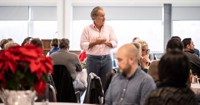 Glenville State University President Dr. Mark Manchin (standing) shares his thoughts on the season with faculty and staff members gathered at the Holiday Luncheon. (GSU Photo/Kristen Cosner)