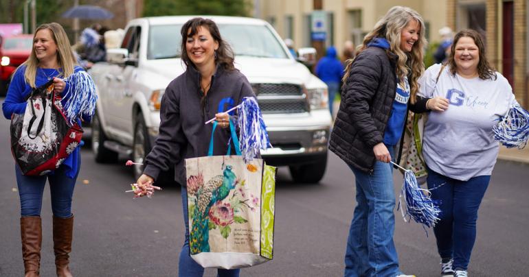 Returning Glenville State cheerleaders toss candy to attendees as they make their way down the parade route during the 2021 Homecoming festivities. (GSU Photo/Kristen Cosner)