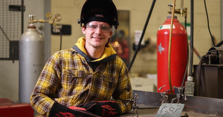 Jesse Kargol Glenville State College student Jesse Kargol with some of his welding designs (GSC Photo/Kristen Cosner)