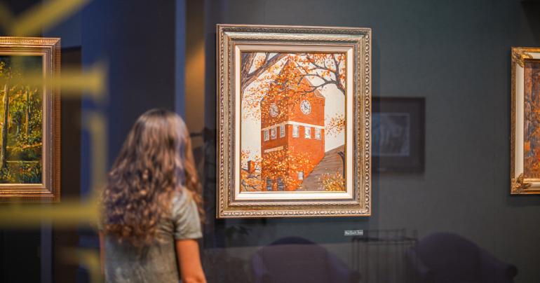A student views artwork in the Jim Rogers Retrospective Art Exhibit that is currently on display at Glenville State College. (GSC Photo/Kristen Cosner)