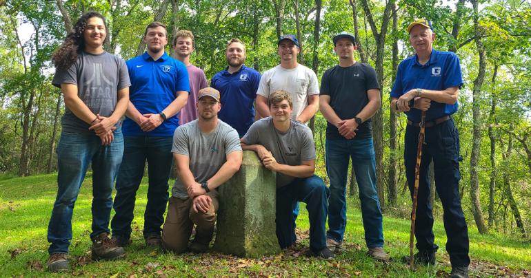 Glenville State University students and faculty members at the “terminal point” of the Mason-Dixon line. The group includes (l-r) Gabe Soto, Billy Harkins, John Kolodziej, Abe Stearns, Jacob Petry, Jack Hadley, Jacob Hoyt, Bryan Utt, and Rick Sypolt. (Courtesy photo)