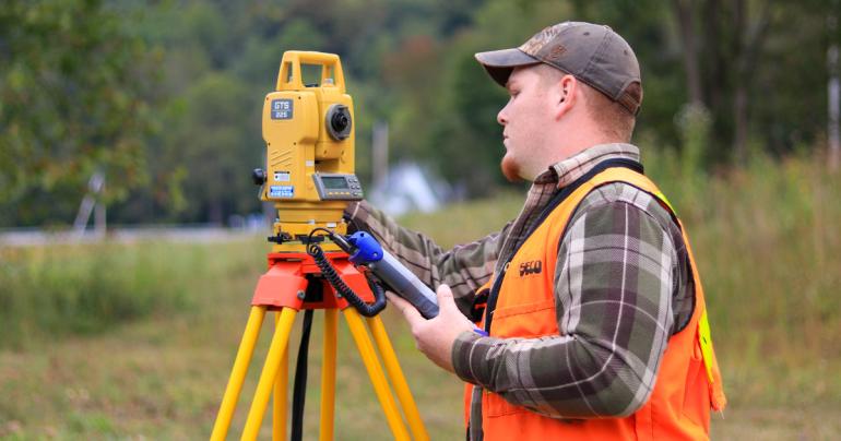 Land Surveying Reunion A former Glenville State University student uses land surveying equipment in the field. Graduates of the land surveying program are invited back to Glenville State for a reunion celebrating 50 years of the program. (GSU Photo/Kristen Cosner)