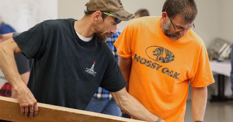 Participants inspect a board during the Lumber Grading Training workshop that was held at Glenville State University recently. The training was sponsored by the Appalachian Hardwood Training Initiative and the National Hardwood Lumber Association. (GSU Photo/Seth Stover)