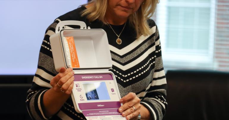 Susie Mullens, Director of the West Virginia Collegiate Recovery Program, holds a ONEbox Naloxone kit during a training session with students at Glenville State University. (GSU Photo/Dustin Crutchfield)