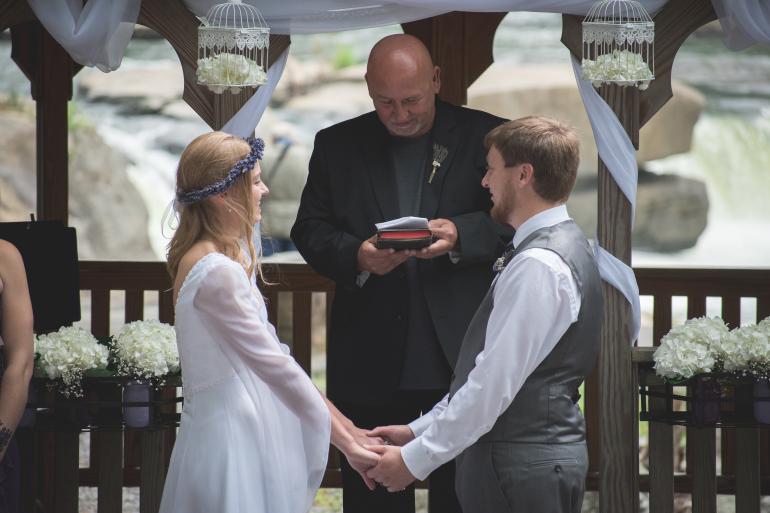 Fred Walborn (center) officiates the wedding of Joanna Lamp and Jackson Ranhart on August 5