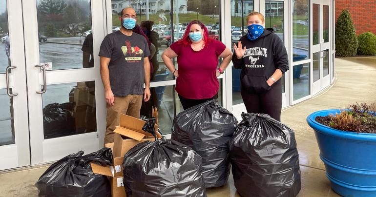 Glenville State University Environmental Science Club advisor Dr. Nabil Nasseri (left) and club members Jessica Green (center) and Veronica Rowse (right) with several bags of recyclable items collected from the Waco Center.