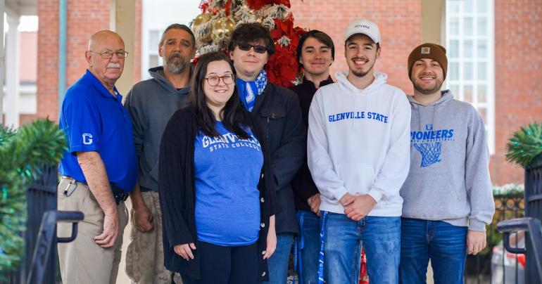 (l-r) Dennis Fitzpatrick, Dave Kennedy, Hannah Rexroad, Garrett Watts, Cody Dye, Nic McVaney, and Conner Ferguson recently spent time hanging Christmas decorations in Downtown Glenville. (GSC Photo/Kristen Cosner)