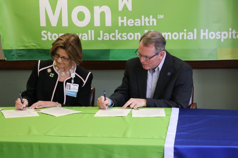 Stonewall Jackson Memorial Hospital CEO Avah Stalnaker and Glenville State College President Dr. Tracy Pellett sign the Memorandum of Understanding