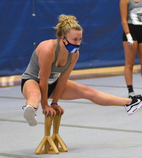 Sadie Eddins practicing straddles in a mask