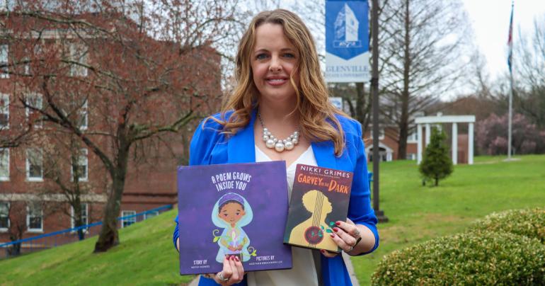Glenville State University Associate Professor of Education and Director of Field Experiences Dr. Shelly Ratliff with copies of “Garvey in the Dark” and “A Poem Grows Inside You.” (GSU Photo/Dustin Crutchfield)