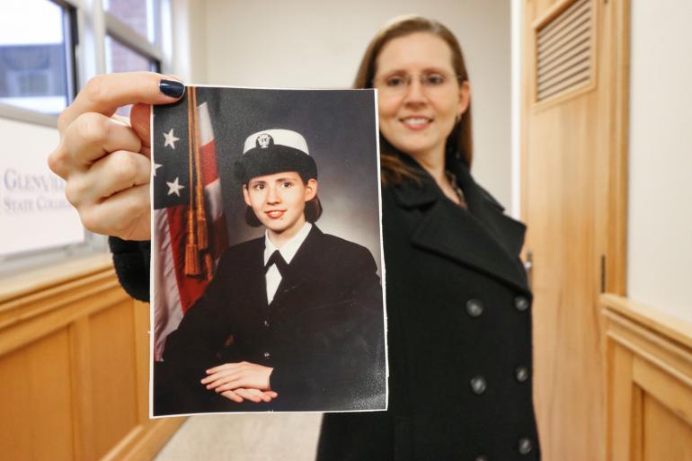 Glenville State College student veteran Sabrina Gonzalez holds a service-era photo of herself