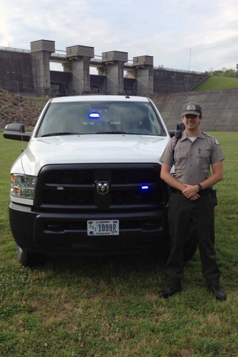 Michael Pracht stands at his patrol vehicle with the Burnsville Dam in the background Michael Pracht stands at his patrol vehicle with the Burnsville Dam in the background