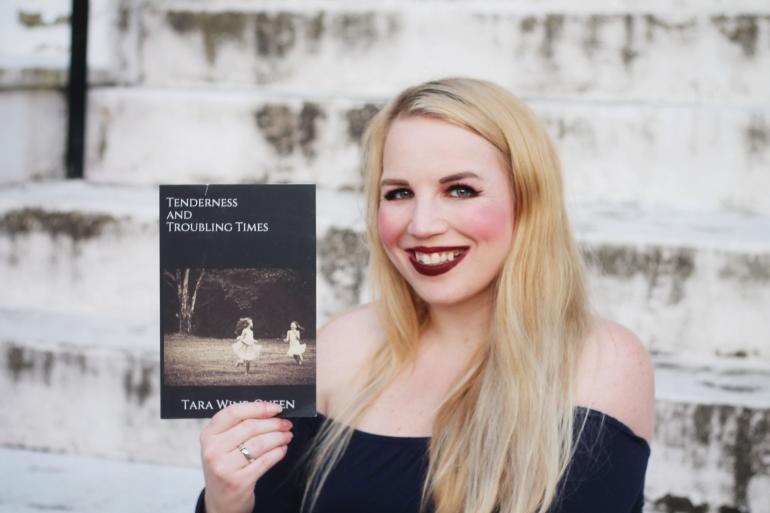 Glenville State graduate Tara Wine-Queen with a copy of her book, "Tenderness and Troubling Times"