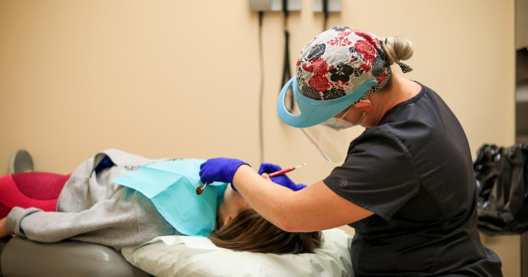 A Glenville State College student receives a cleaning by a Minigh Family Dentistry employee during their on-campus dental clinic visit (GSC Photo/Kristen Cosner)