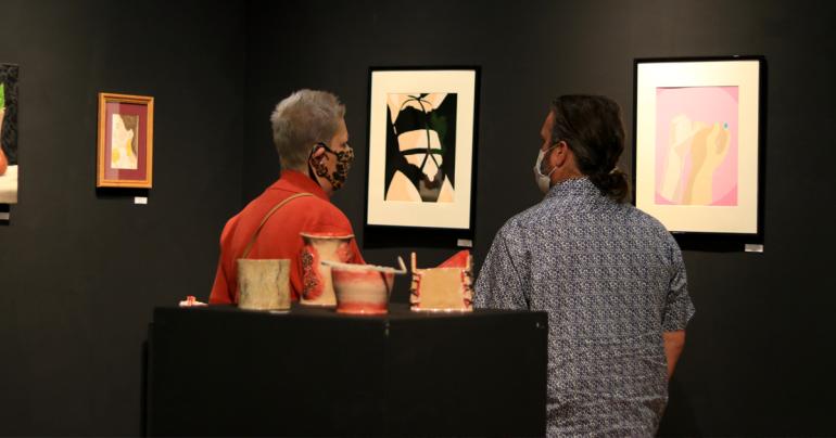 Department of Language and Literature faculty members Dr. Marjorie Stewart (left) and Dr. Jonathan Minton browse Trillium Art Show entries during the 2021 show. The 2022 show will be on display February 1-11 with an opening reception on Friday, February 4.