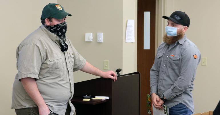 Glenville State College graduate and current WV Division of Natural Resources Wildlife Manager Mitch Queen (left) chats with Jacob Petry during his recent visit to GSC.
