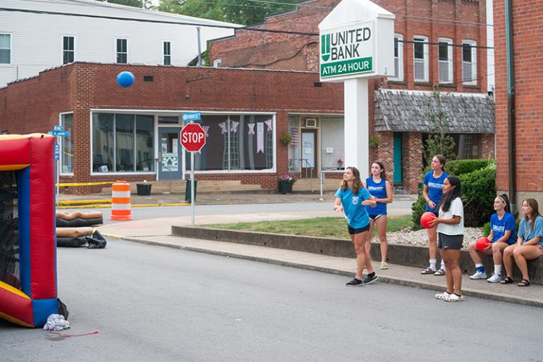 Students playing giant connect four at a block party