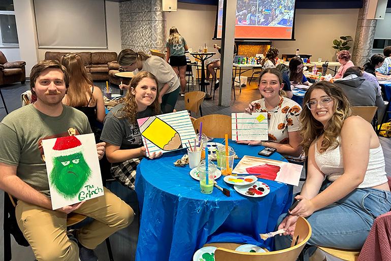 Students show off some painted artwork