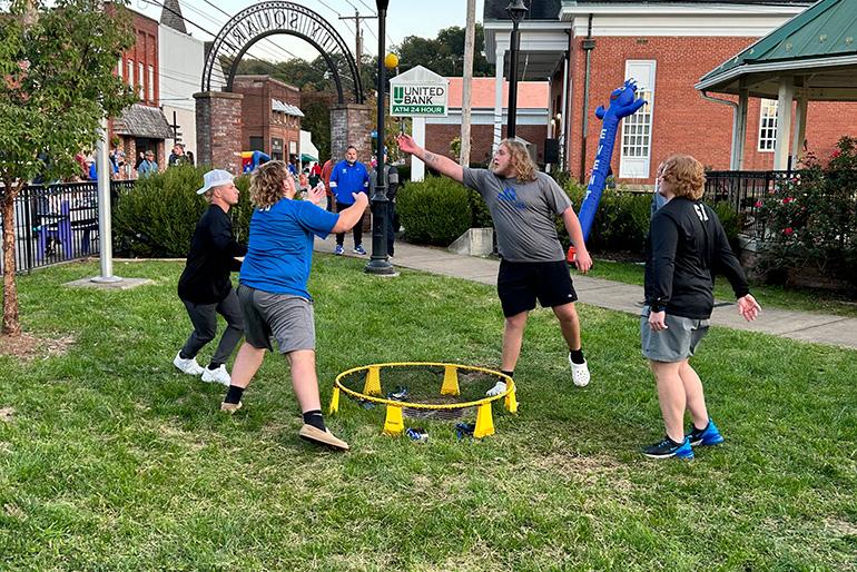 Students play a game in the local park