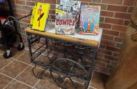 Books and comicbooks on a stand in the library.
