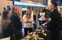 Students talk with a recruiter at a past Glenville State University Career and Graduate School Expo.