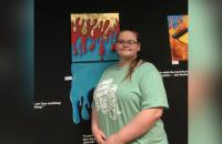 Glenville State University student Carla Bowman with some of the pieces that are on display as part of her Senior Art Show.