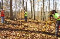 Glenville State College Honors Program students (l-r) Eli Henthorn, Asa Dick, and Jacob Amick survey a family cemetery in rural Gilmer County.