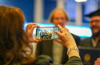 Glenville State University Dean of Education Connie Stout O’Dell takes a photo of a graduate and their family at Commencement in May 2022. The spring 2023 ceremony will take place on Saturday, May 6 at 10:00 a.m. (GSU Photo/Kristen Cosner)